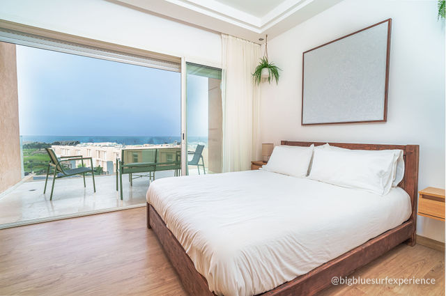 Ocean-view bedroom of the BigBlue Bay Duplex with a king bed and its own balcony