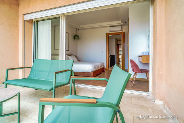 Private balcony of the ocean-view bedroom in the BigBlue Bay Duplex, sliding doors open